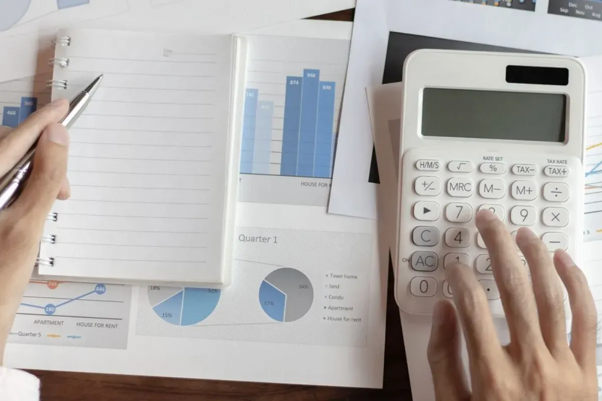 Financial analysis spreadsheet and charts on a desk